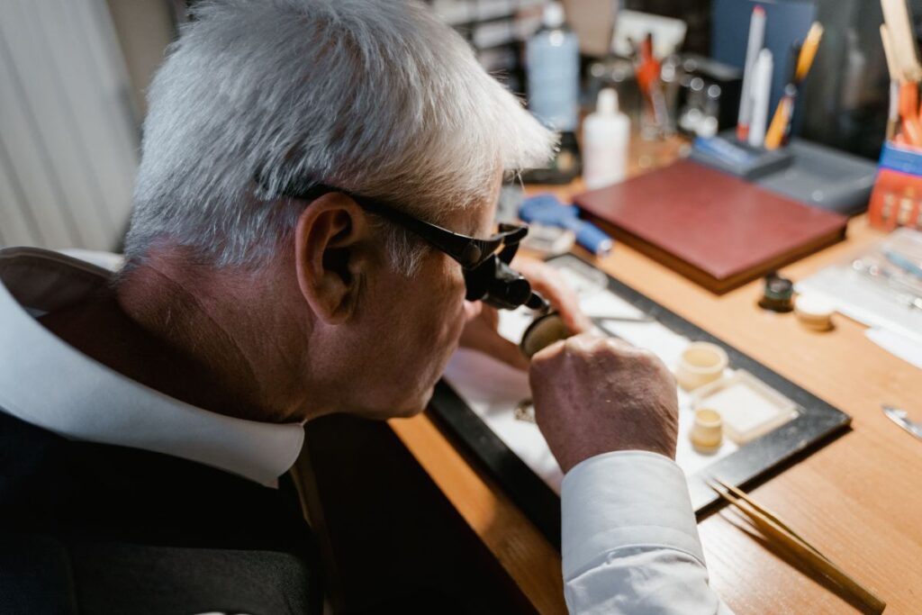 Watchmaker working at its desk