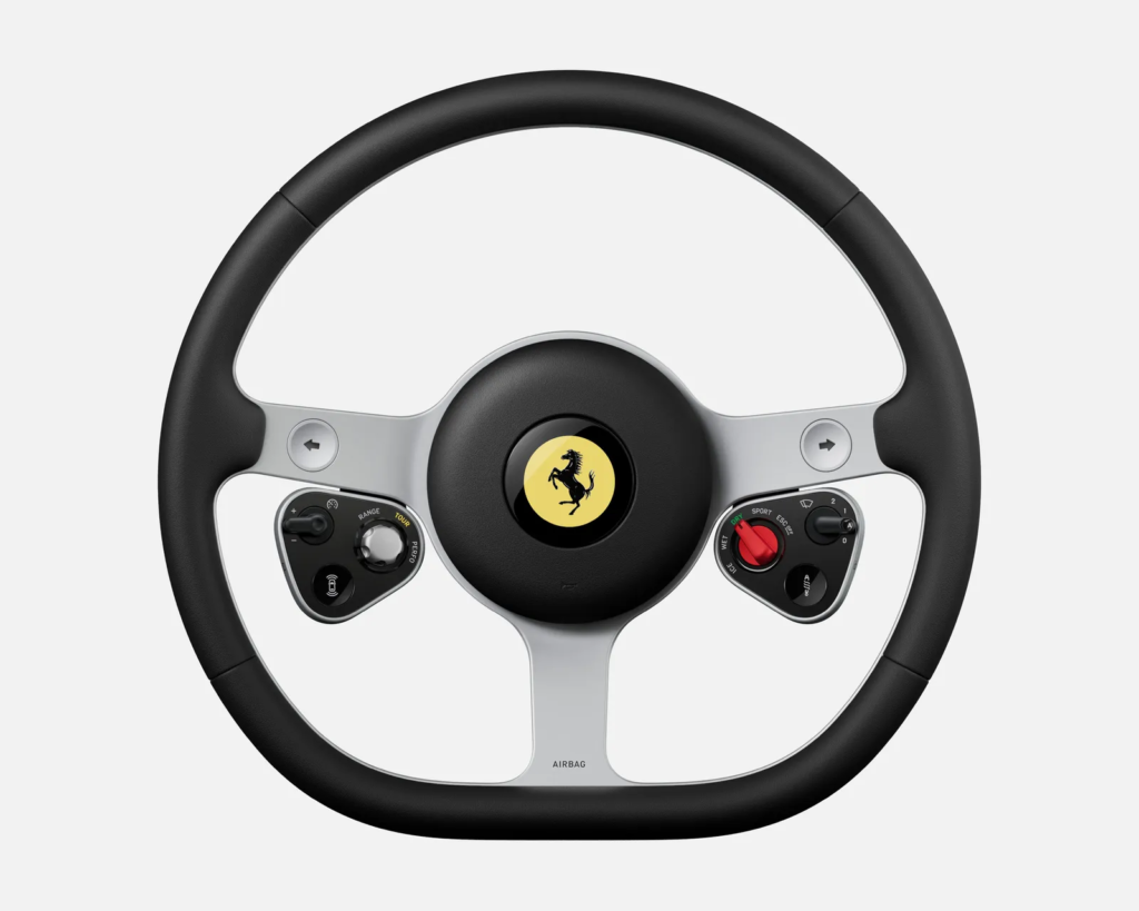Dettaglio degli interni della Ferrari Luce progettati con LoveFrom di Jony Ive e Marc Newson, caratterizzati da alluminio satinato, controlli fisici e design minimalista